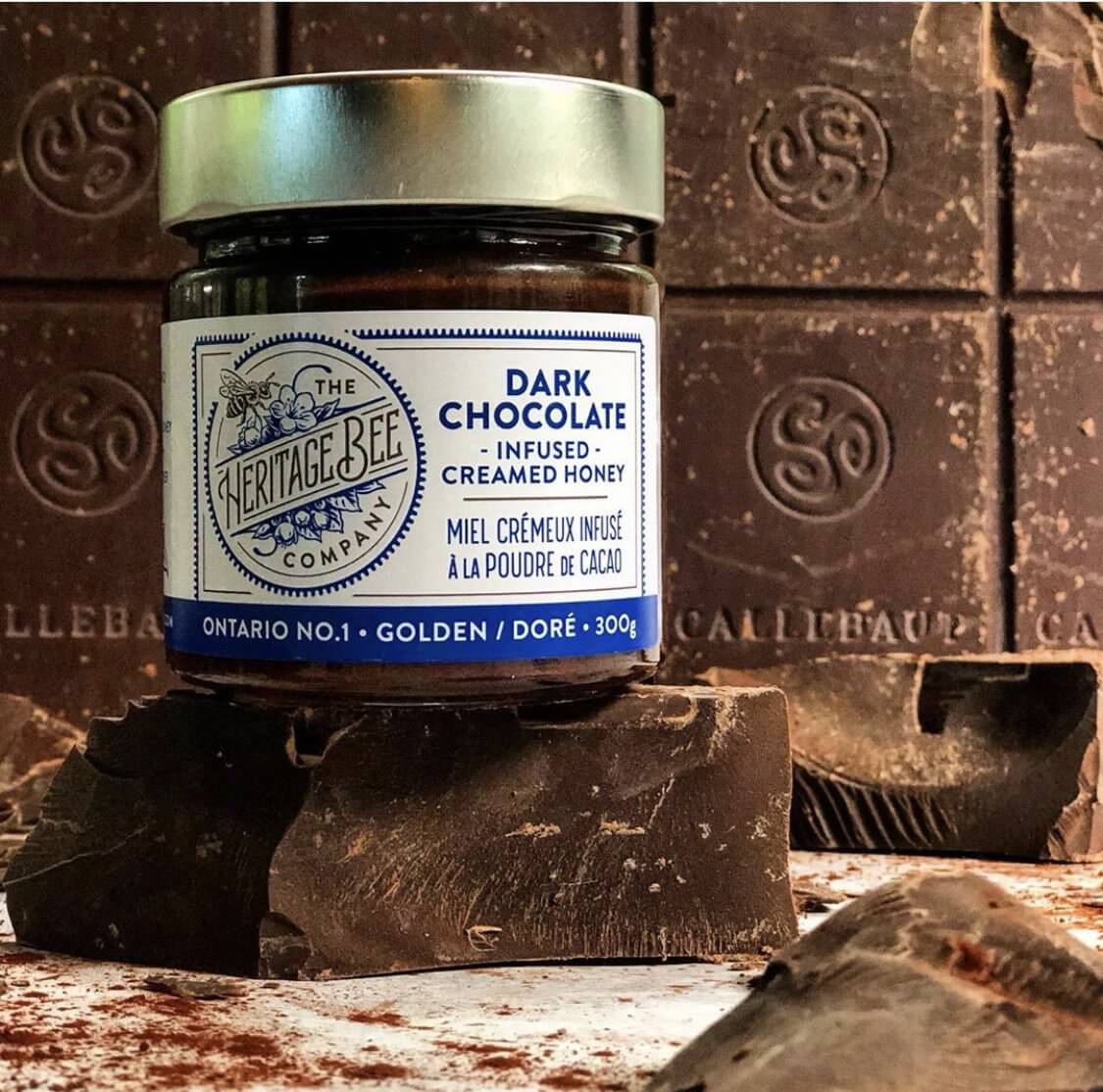 Heritage Bee Co's gourmet dark chocolate infused creamed Ontario wildflower honey in front of Callebaut chocolate.